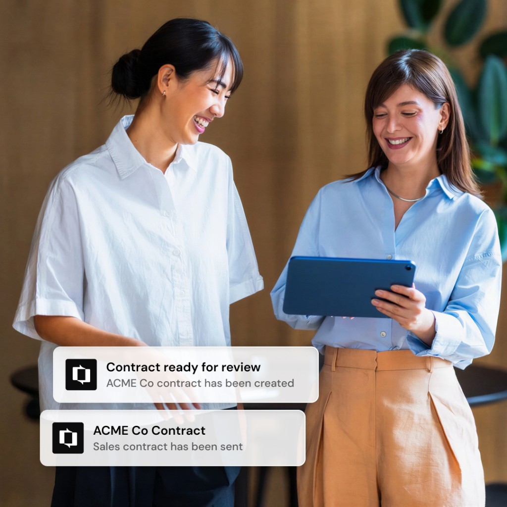 Two colleagues reviewing a contract on a tablet