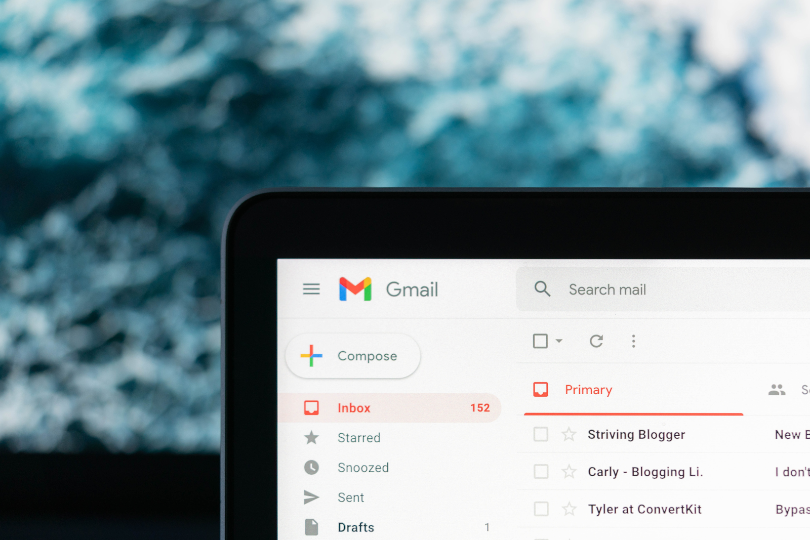 Gmail inbox open on a laptop screen showing unread emails – How to write an invoice email with a free email invoice template for businesses and freelancers.